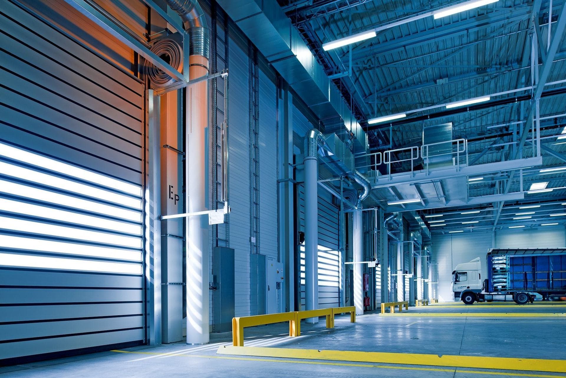 Interior of a large industrial building with steel structure and machinery