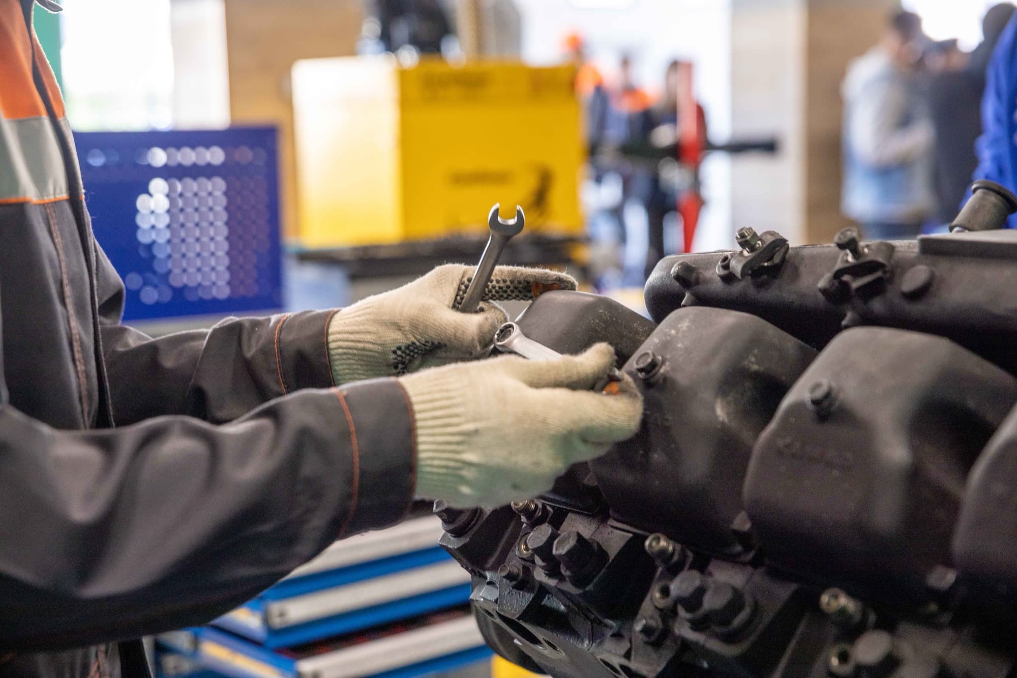 Engineer working on an industrial engine with a spanner